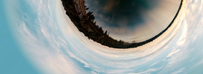 Distorted land and sky viewed through fisheye lens